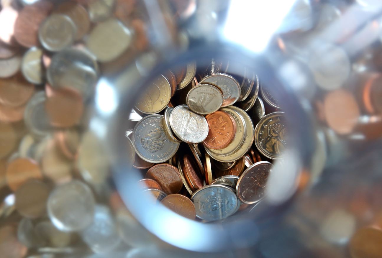 Coins inside a clear glass jar, canadian currency only