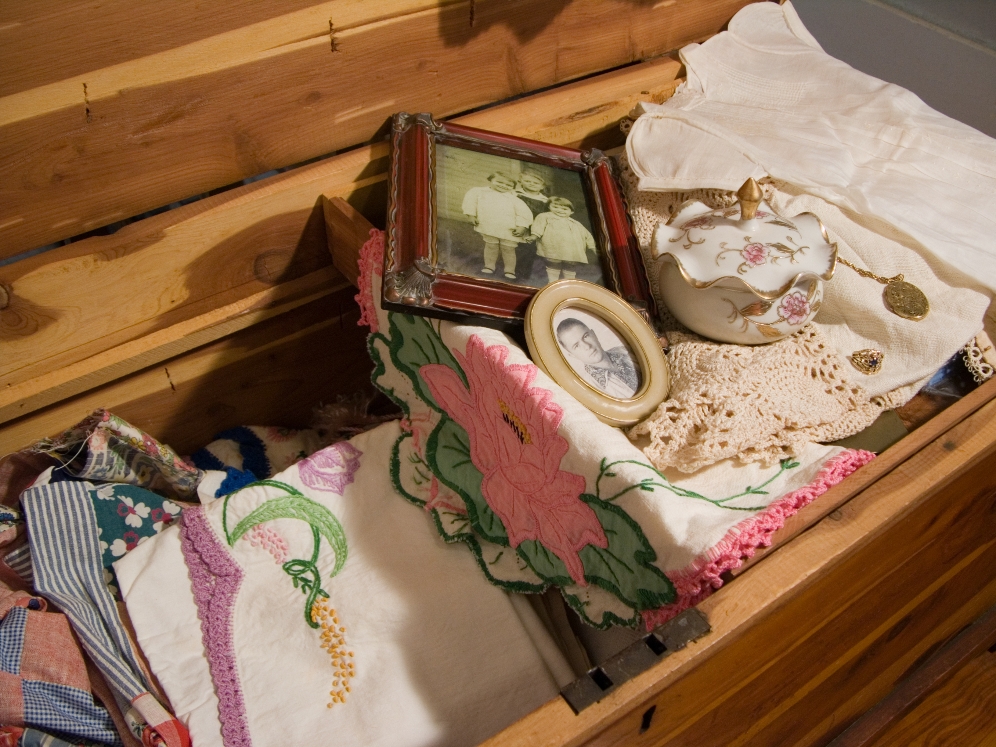 antique cedar chest with vintage linens, photographs and knicknacks