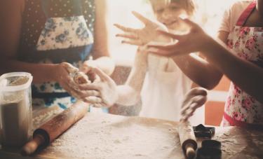 Multigenerational family cooking a pie together