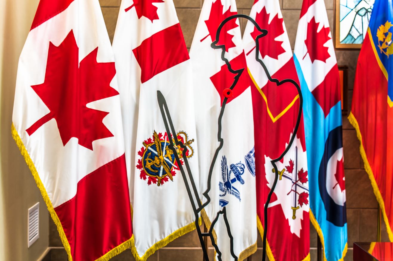 Tommy silhouette in the hall of colours in front of Canadian and Canadian military flags